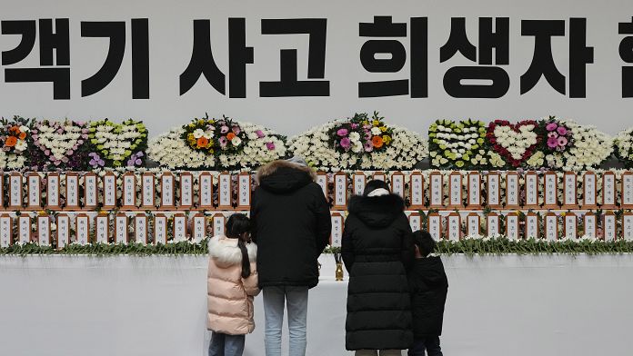 People lay flowers at to remember 179 victims of Sunday’s plane crash in Muan