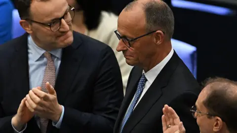 Getty Images Friedrich Merz, Germany's new chancellor in the centre of the picture, is congratulated by colleagues