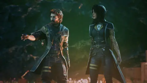 Sandfall Interactive Screenshot shows a bearded male character and a female companion, both wearing leather-effect outfits. They appear to be in some sort of cavern, with luminous plants emitting an eerie pink glow around them.