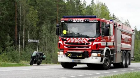 Reuters A fire department vehicle is seen on a road near woodland, near the crash site in Eura, Finland