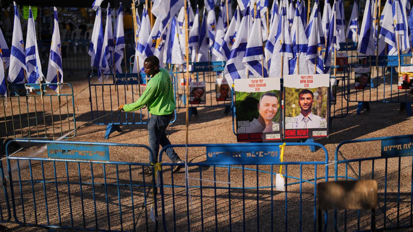 The Latest: Israel to halve aid into Gaza over slow return of dead hostages