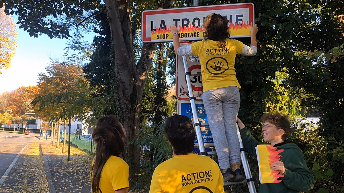 Hundreds of road signs and billboards in France have been decorated with fake flames. Here’s why