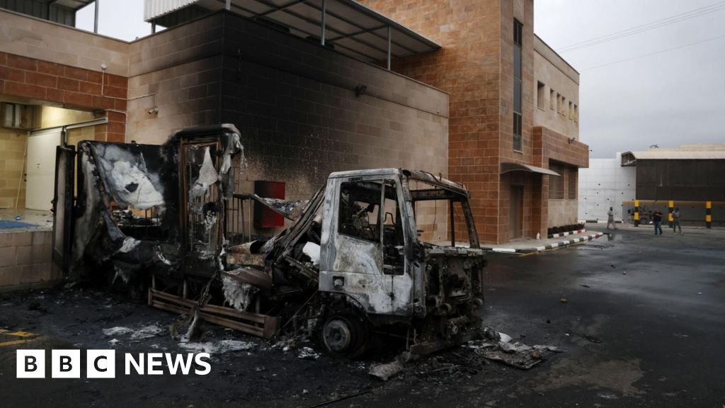 Israeli settlers set fire to Palestinian warehouse and land as West Bank attacks surge