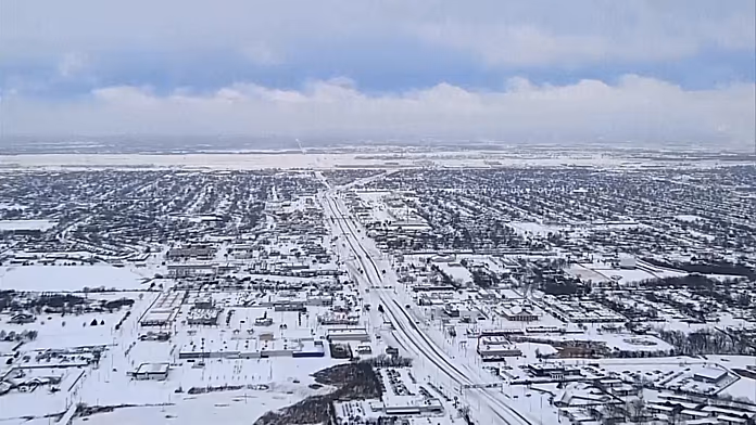 Drone footage shows snow-covered US cities, snow plows at work