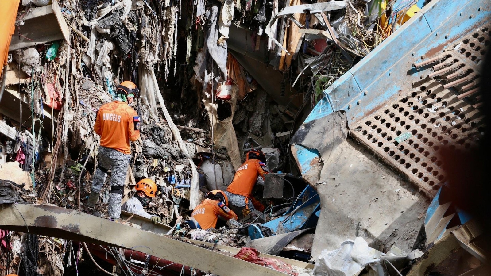 Filipino rescuers detect ‘signs of life’ in deadly garbage avalanche; dozens missing